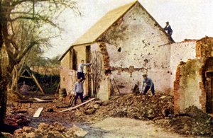 Four men working on a house that was severely damaged during the Battle of the Marne east of Paris, September 1914